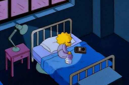 Lisa Simpson lies on her bed listening to an old tape player. She looks sad.